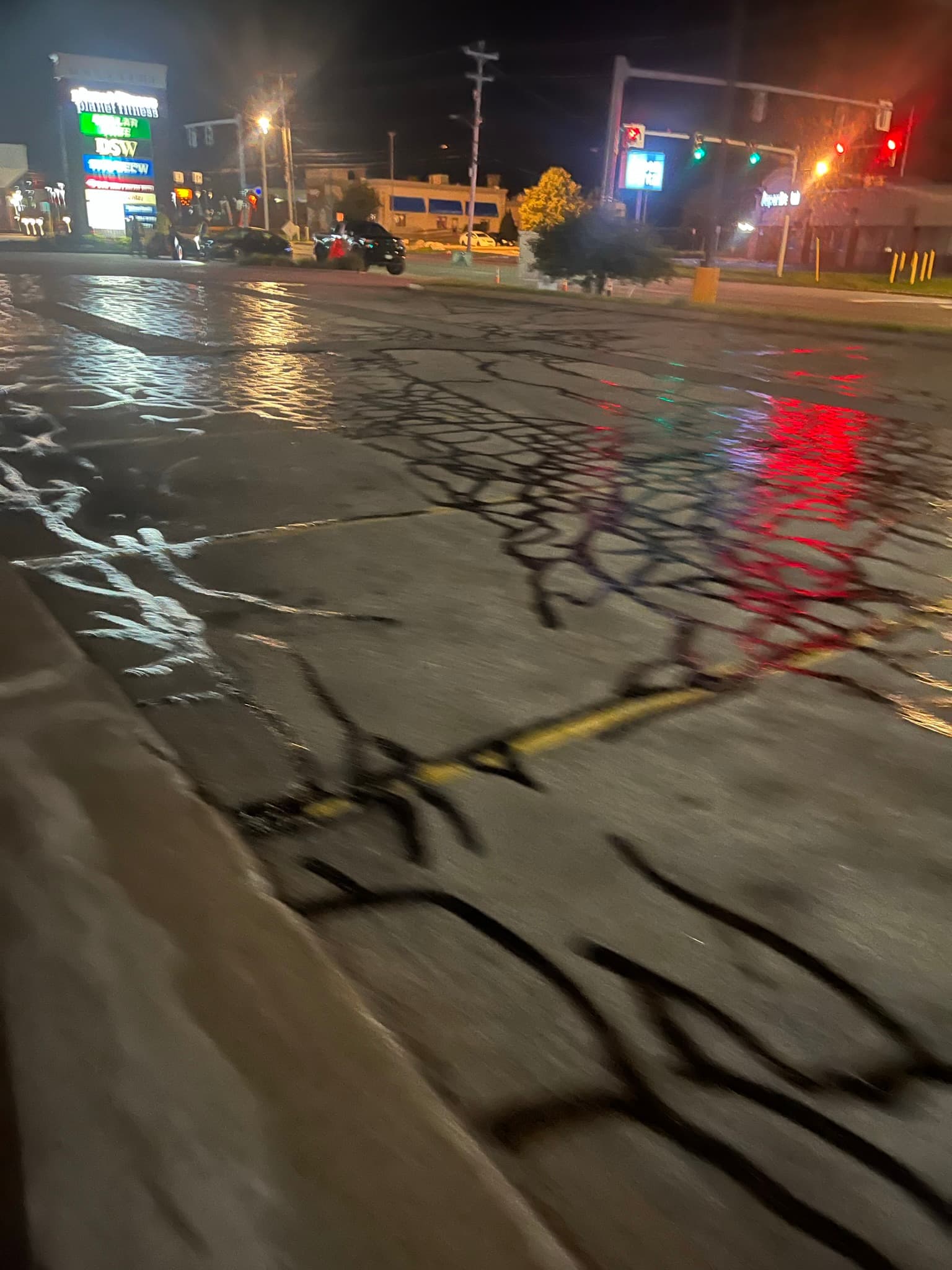 Crack repair on deteriorated driveway, hot-rubber sealing wide cracks
